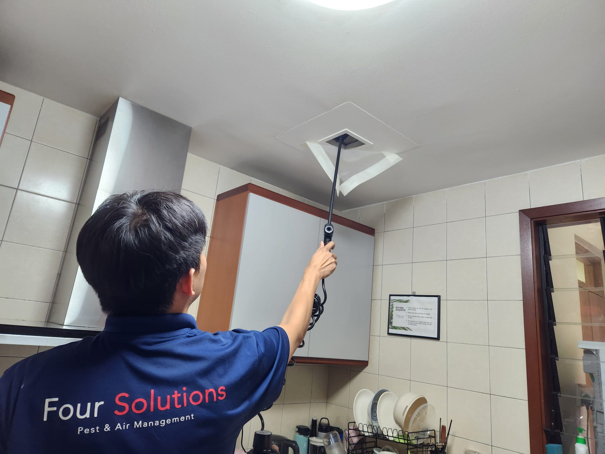 Four Solutions technician applying indoor residual spray in a home