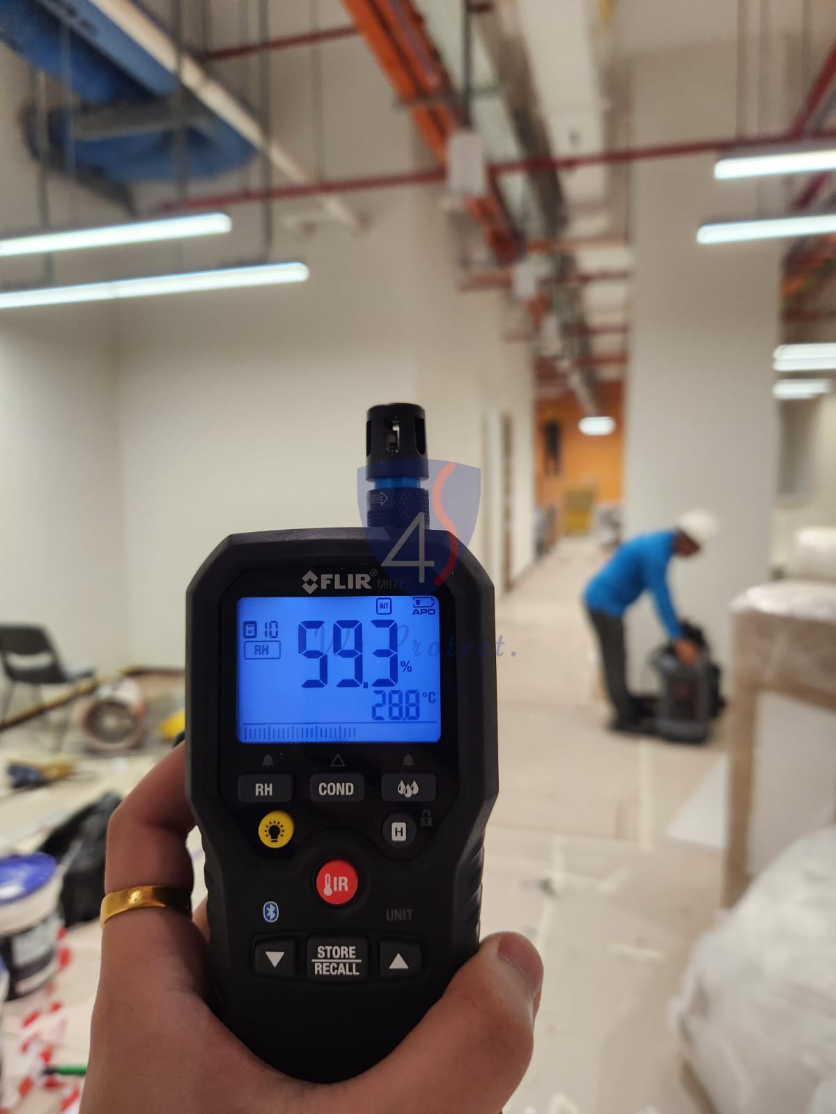 Four Solutions taking a thermal moisture reading on a commercial site in Singapore